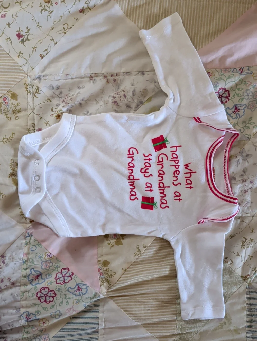 White Baby Onesie with Pink Trim and Holiday Gift Graphic